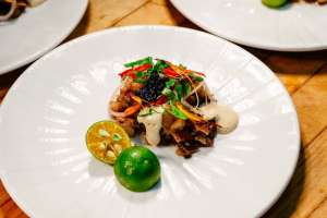 Filipino sisig dish with wine.